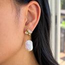 Gold baroque pearl drop earrings, close-up worn on model