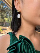 Gold baroque pearl drop earrings worn on model