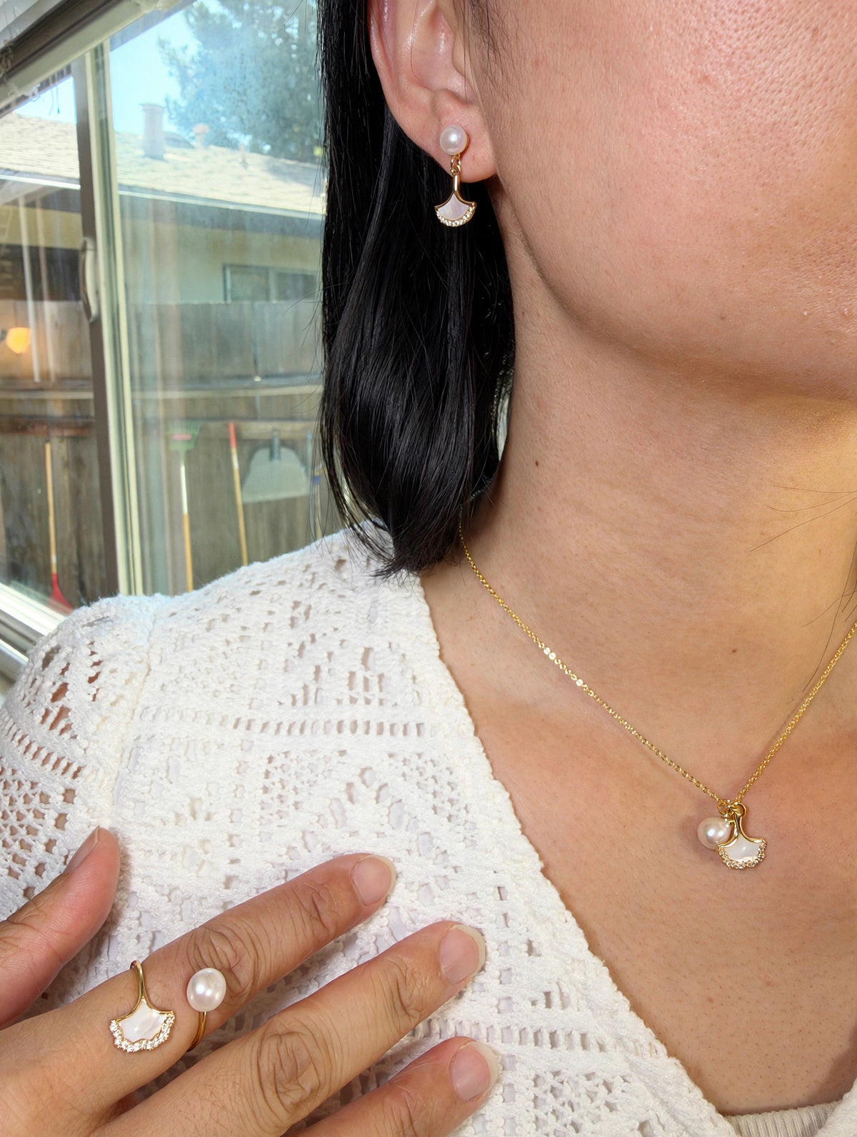 Gold ginkgo leaf pearl jewelry set, necklace earrings and ring worn on model
