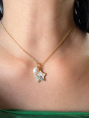 Gold star pearl pendant necklace with mother of pearl worn on model